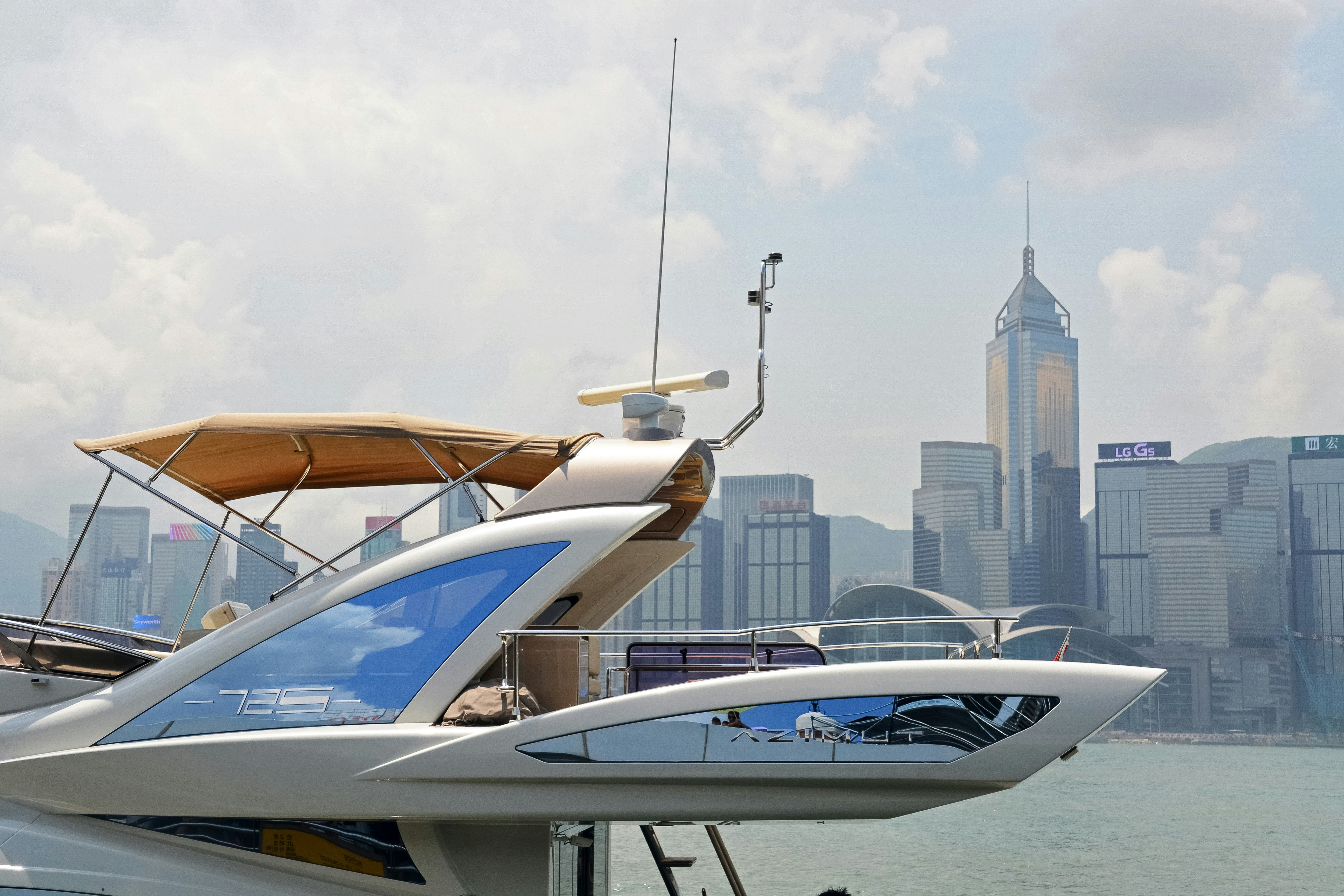 white and blue boat on body of water during daytime